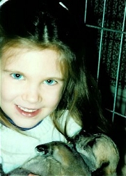 Five year old Kate holding one of Mollie's pups.