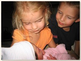 Ashlyn and Drew affectionately meeting their little sister
